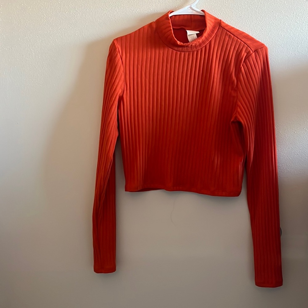 Orange shorter turtle neck long sleeve shirt
